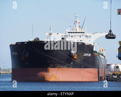 The Cape Ray (IMO 7530810) is a vessel operating in the Port of Amsterdam, navigating the Amerikahaven. The ship is part of a fleet that includes oil tankers, container ships, and tug vessels handling cargo and industrial transport. Stock Photo