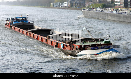 The image shows a container ship navigating the Amsterdam-Rijn Canal ...