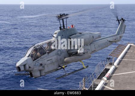 U.S. Marine Corps AH-1W Super Cobra attack helicopter takes off from the flight deck of the amphibious transport dock ship USS Green Bay June 11, 2015 in the East China Sea. Stock Photo