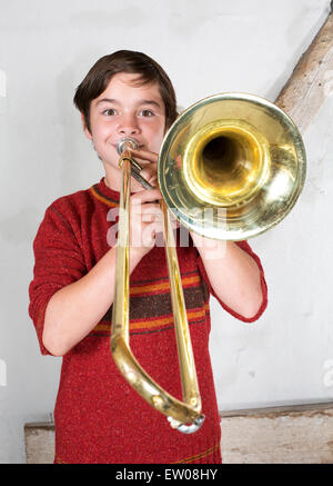 portrait of a boy playing the trombone Stock Photo