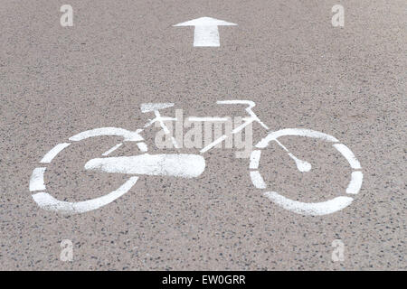 Symbol of a bike depicted on the surface of a road, to mark the path reserved to cyclists. Stock Photo