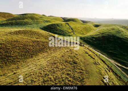 Maiden Castle Iron Age hill fort, Dorset. Four ramparts and three ditches of complex earthwork defences of the western entrance Stock Photo
