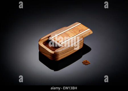 Product shot of snuff box and a pinch of snuff Stock Photo