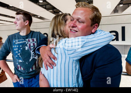 A Mother Welcomes Her Son Home From Travelling, Heathrow Airport, London, England Stock Photo