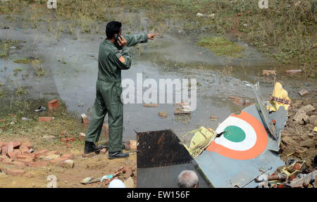 Allahabad, India. 16th June, 2015. An airforce officer giving instruction to worker after a Jaguar fighter aircraft of the Indian Air Force crashed this morning at Chaka in Naini near Allahabad in Uttar Pradesh. Both the pilots managed to eject safely. The plane which had taken off at 7:25 am from the Bamrauli air strip in Allahabad was on a routine training sortie. The pilots reportedly sent signals to the ground staff that there was some major technical glitch with the aircraft. © Prabhat Kumar Verma/Pacific Press/Alamy Live News Stock Photo