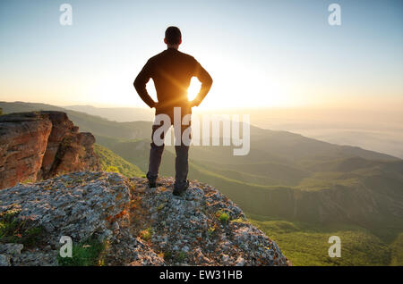 Man on top of mountain. Conceptual scene. Stock Photo