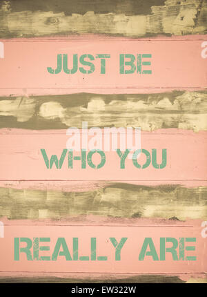 Concept image of JUST BE WHO YOU REALLY ARE motivational quote written on vintage painted wooden wall Stock Photo