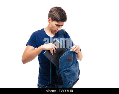 Male student putting folder in backpack isolated on a white background Stock Photo