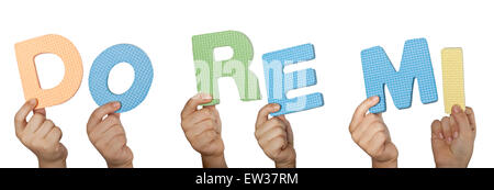Child hand holding Do Re Me, the first three musical notes used in solfege isolated on white background Stock Photo