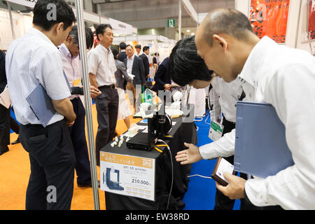 Tokyo, Japan. 17th June, 2015. Visitors looks at a 3D printer on display at the Smart Community Japan 2015 in exhibition in Tokyo, Big Sight on June 17, 2015, Tokyo, Japan. The exhibition promotes both domestic and overseas next-generation technologies. The last year 39,879 visitors attend the expo during three days. This year 233 enterprises and organizations will show their products from June 17th to 19th. Credit:  Rodrigo Reyes Marin/AFLO/Alamy Live News Stock Photo