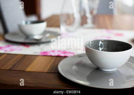 closeup of cup and plate on wooden table Stock Photo