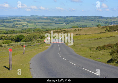 Looking down Pork Hill towards Tavistock with a cattle grid at an entrance to Dartmoor National Park, Devon, England Stock Photo