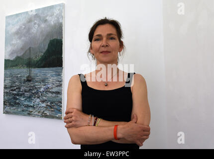 Duesseldorf, Germany. 11th June, 2015. Painter and graphic artist Sabine Moritz, wife of the painter Gerhard Richter, whose artworks are the most expensive of a living artist on the art market, poses in the gallery 'Felix Ringel' during the exhibition opening of an exhibition displaying her paintings and drawings in Duesseldorf, Germany, 11 June 2015. Photo: HORST OSSINGER/dpa/Alamy Live News Stock Photo