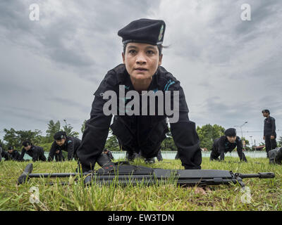 June 17, 2015 - Rangae, Narathiwat, Thailand - A Thai woman Ranger does pushup during drills at the Ranger camp in Rangae, Narathiwat province. There are 5 platoons of women Rangers serving in Thailand's restive Deep South. They generally perform security missions at large public events and do public outreach missions, like home wellness checks and delivering food and medicine into rural communities. The medics frequently work in civilian clothes because the Rangers found people are more relaxed around them when they're in civilian clothes. About 6,000 people have been killed in sectarian viol Stock Photo