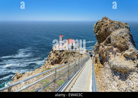 Ladder down to the sea and lighthouse on the rock.  Point Reyes Lighthouse, California, USA Stock Photo