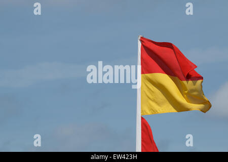 Flag put out by beach patrol or life guards flapping in the breeze.  The flag marks the safe swimming and body boarding zone Stock Photo