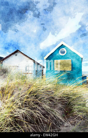 Beach huts and boats in sand dunes at Mudeford Spit on Hengistbury Head near Christchurch in Dorset. Stock Photo