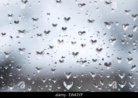 Heart shaped water droplets on window Stock Photo