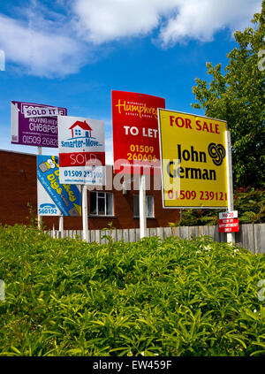 Brightly coloured For Sale To Let and Sold signs on a street in Loughborough Leicestershire England UK Stock Photo