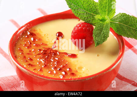 Creme brulee in a red dish Stock Photo