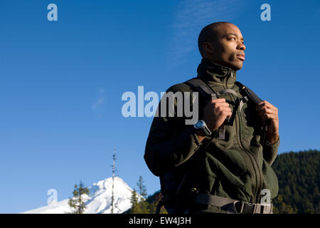 African American man Cupid Alexander hikes on trail near Mt. Hood in the Cascade Mountains Oregon. Stock Photo
