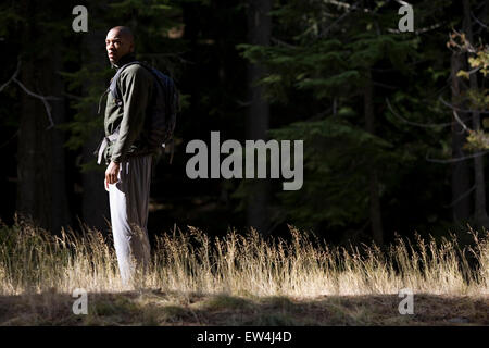 African American man Cupid Alexander rests on trail in forest in the Cascade Mountains Oregon. Stock Photo