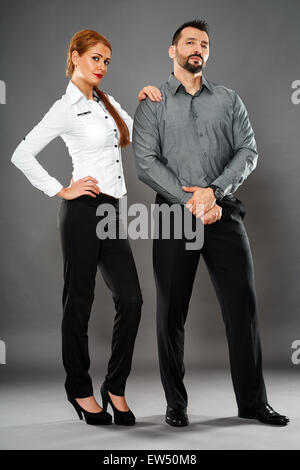 Mixed gender business team full length on gray background Stock Photo