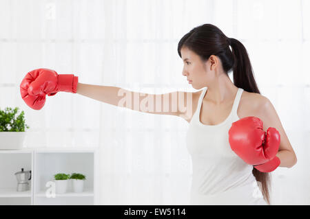 Young woman wearing box glove and looking away Stock Photo