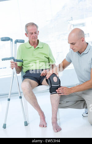 Doctor examining his patient knee