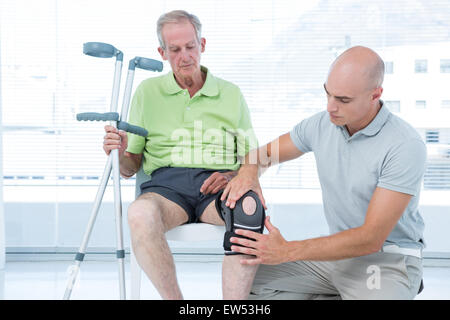 Doctor examining his patient knee