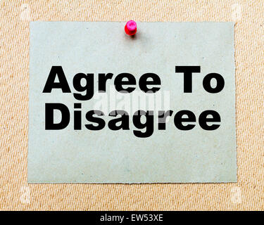 Agree To Disagree written on paper note pinned with red thumbtack on wooden board. Business conceptual Image Stock Photo