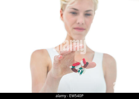 Blonde woman throwing away batch of pills Stock Photo