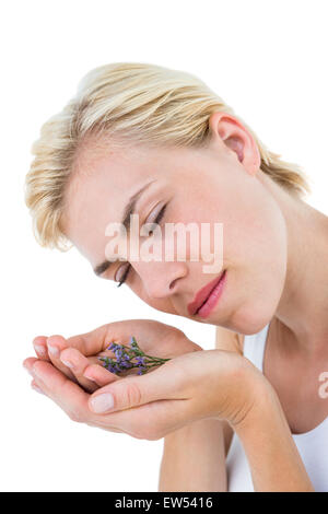 Gorgeous blonde woman smelling flowers Stock Photo