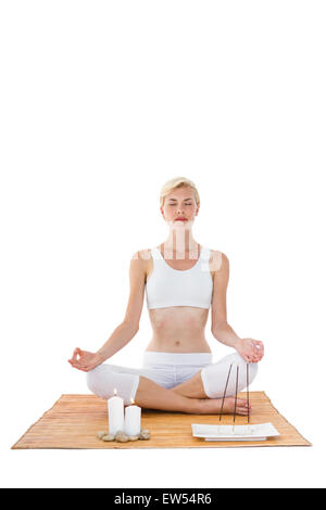 Fit woman meditating on bamboo mat Stock Photo