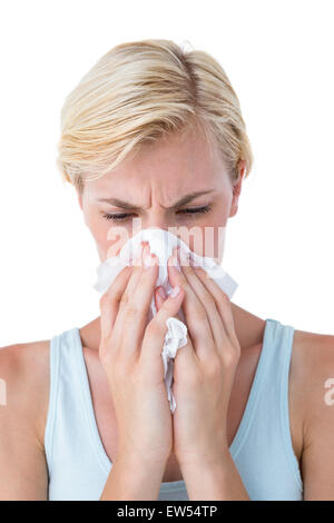 Attractive woman blowing her nose