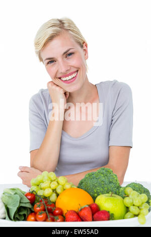 Happy blonde woman sitting above healthy food Stock Photo