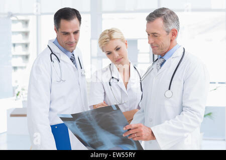 Concentrated doctors looking at Xray Stock Photo - Alamy