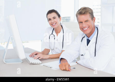 Smiling female and male doctors looking at camera Stock Photo