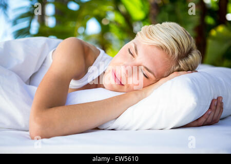 Beautiful blonde woman lying outside Stock Photo
