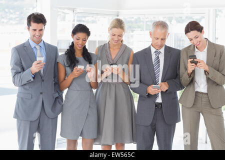 Employees using their mobile phone Stock Photo