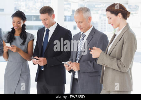 Employees using their mobile phone Stock Photo