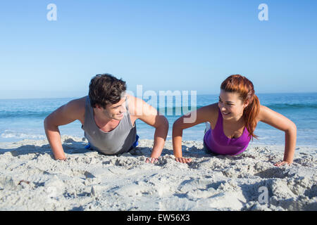 Happy couple doing push ups together Stock Photo - Alamy