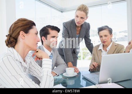 Business team working together on laptop Stock Photo
