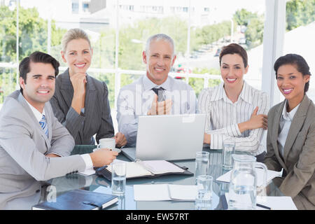 Happy business team working at desk together Stock Photo