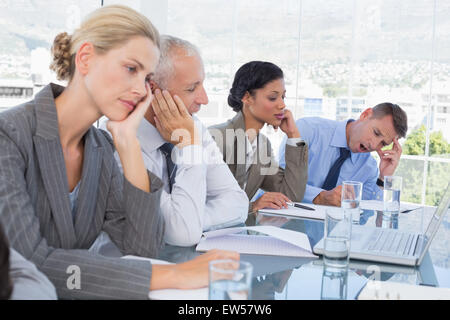 Tired business team at conference Stock Photo