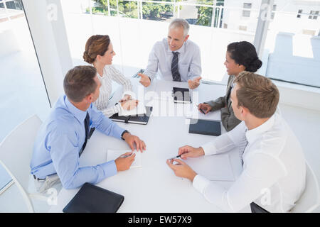 Business team sitting together around the table Stock Photo