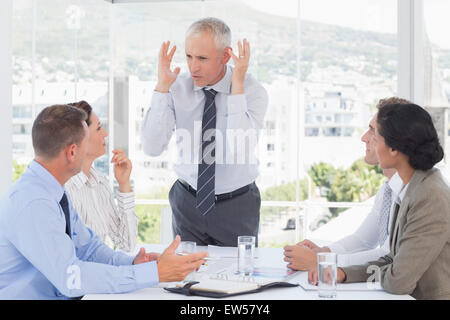 Irritated businessman talking to his team Stock Photo