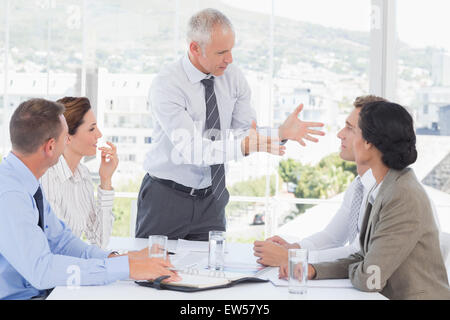 Businessman yelling at his team Stock Photo