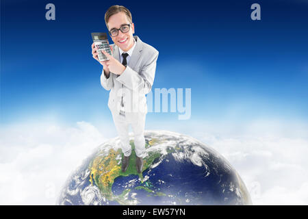 Composite image of geeky smiling businessman showing calculator Stock Photo