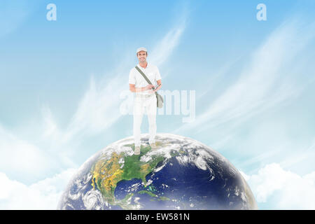 Composite image of happy delivery man using digital tablet Stock Photo